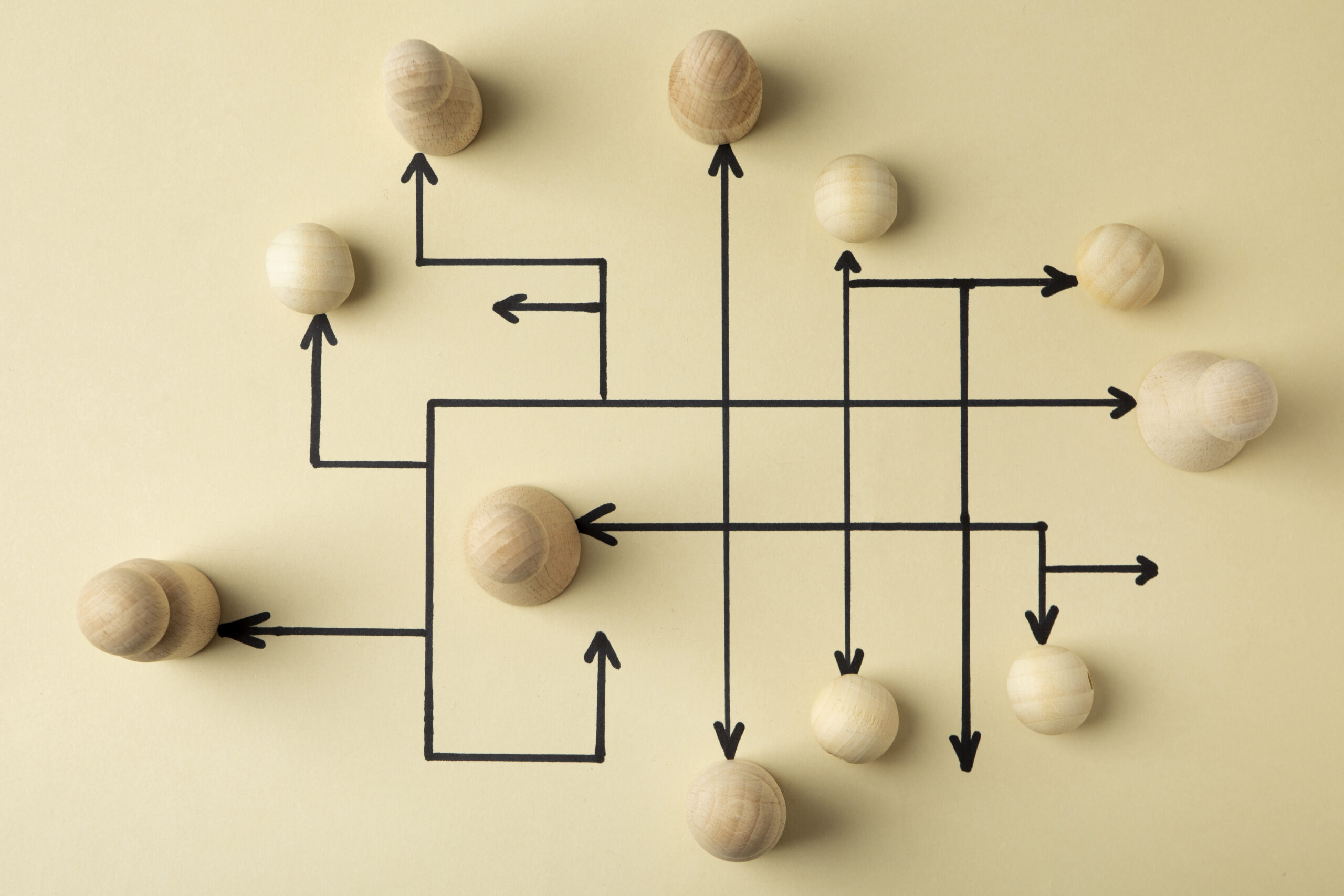 top-view-wooden-pawns-arrangement Wooden pawns arranged on a board — a strategy and management metaphor